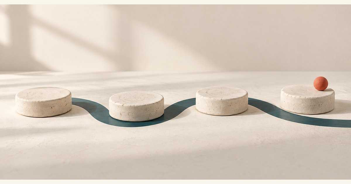 Four spaced ceramic discs form a steady sequence beside a curved teal band.