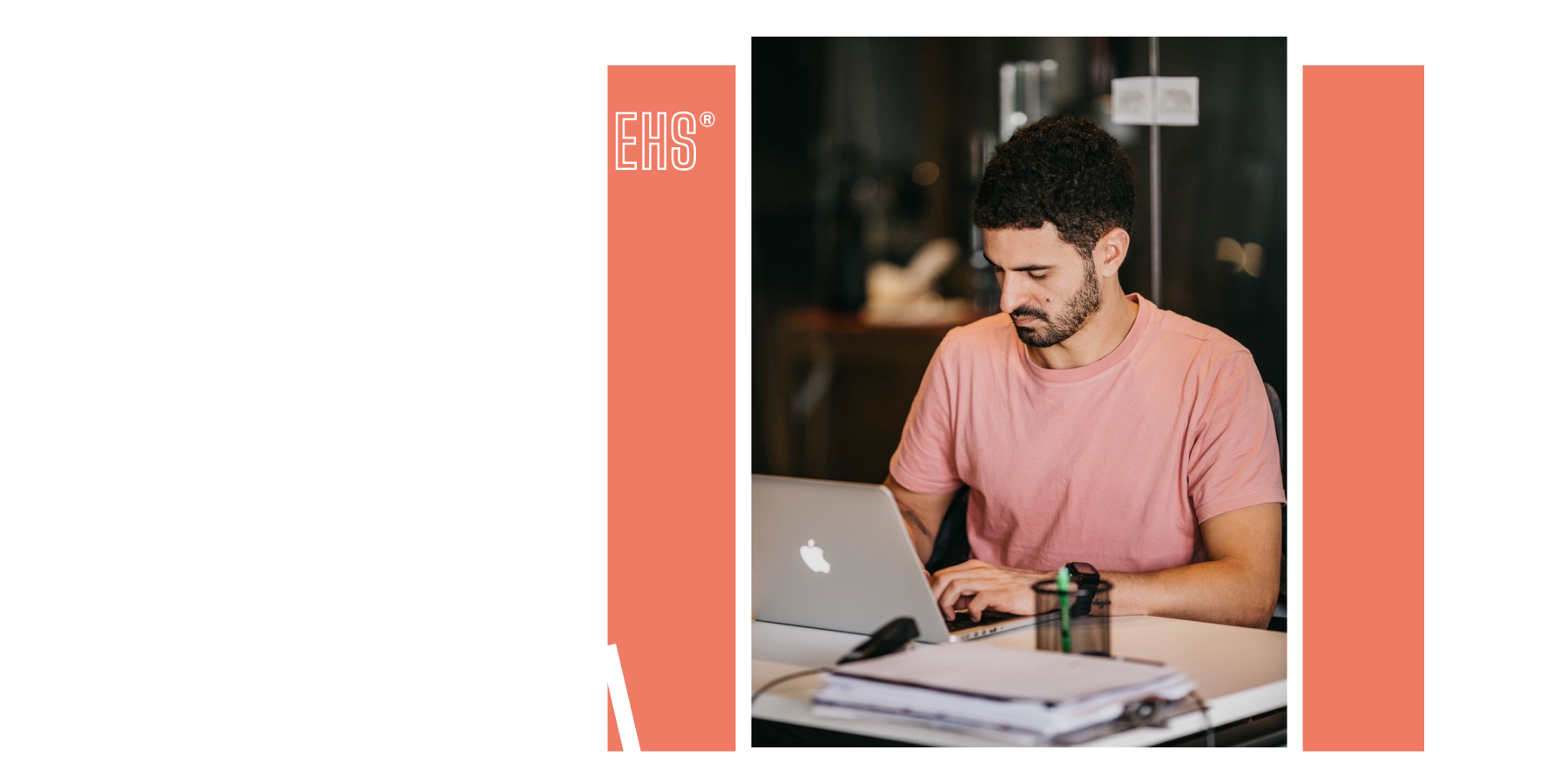 Employee concentrating on a laptop during a normal working day with EHS branding