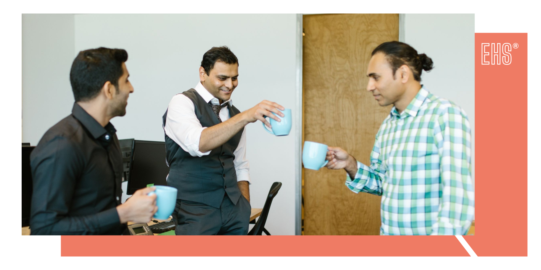Colleagues sharing a friendly coffee break in an office with EHS branding