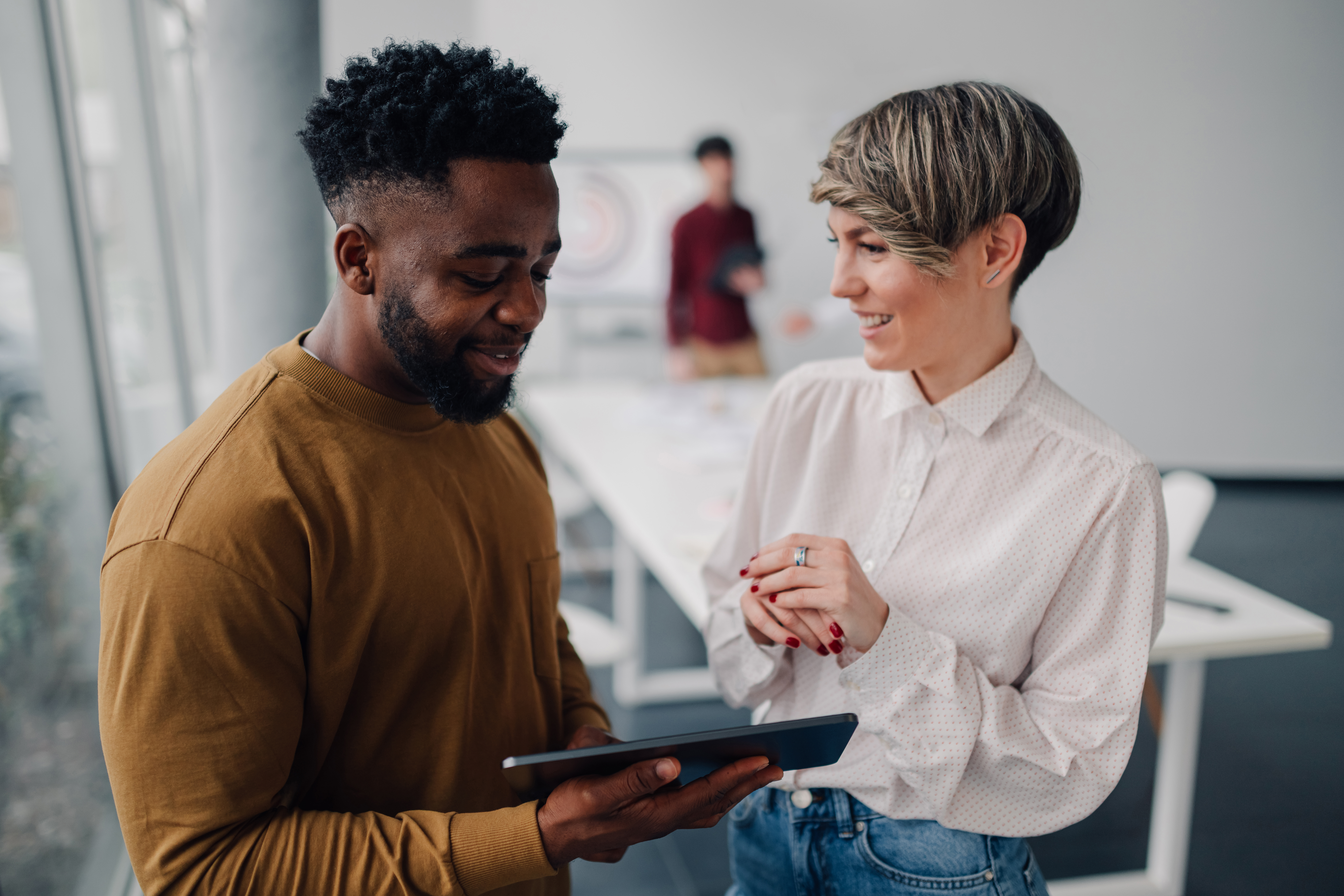 smiling-business-colleagues-using-digital-tablet-i-2026-01-09-11-55-24-utc