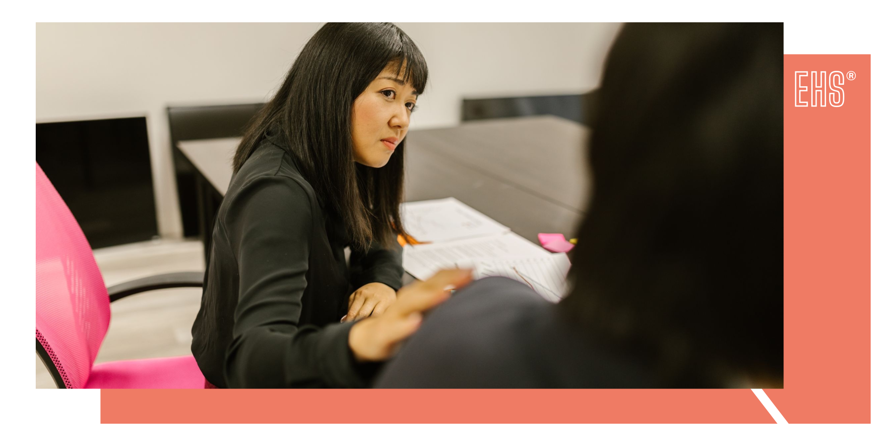 Colleague listening during an office discussion with EHS branding